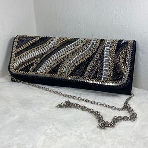 Bebe clutch with metal chain and jewel embellishment 11.5” by 4.5”